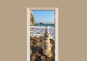 Deursticker witte stenen op het strand